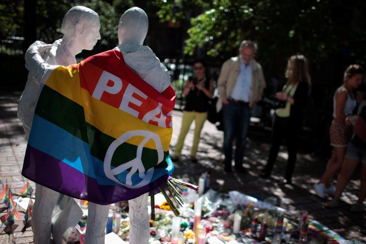 People visit a makeshift memorial to remember the victims of the mass shooting at a gay nightclub in Orlando, in Christopher Park outside the Stonewall Inn in Manhattan, New York, U.S., June 15, 2016.
