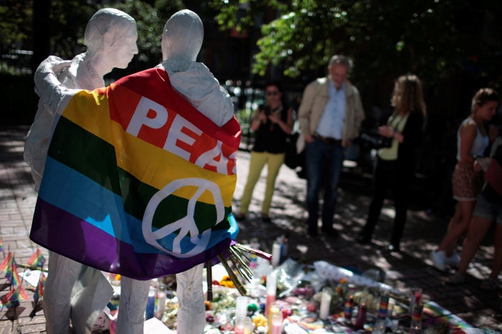 People visit a makeshift memorial to remember the victims of the mass shooting at a gay nightclub in Orlando, in Christopher