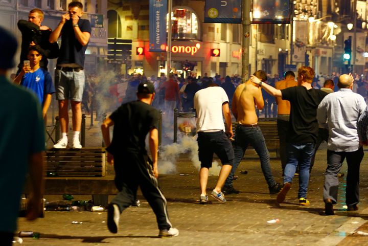 England fans run from tear gas in Lille.