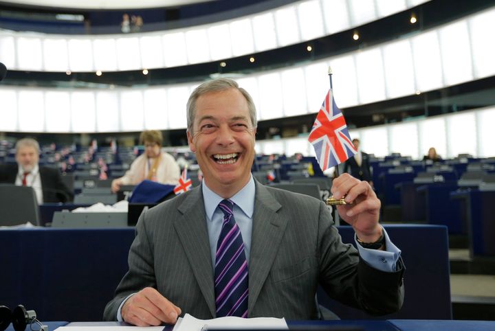 Nigel Farage, leader of the United Kingdom Independence Party (UKIP) and Member of the European Parliament holds a British Union Jack flag as he waits for the start of a debate at the European Parliament in Strasbourg.