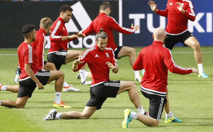 Wales Gareth Bale, centre, stretches during a training session at the Bollaert stadium in Lens