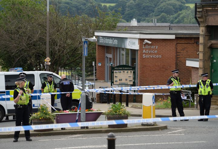<strong>Police stand guard on the perimeter of the crime scene outside the library in Birstall where Jo Cox was shot</strong>