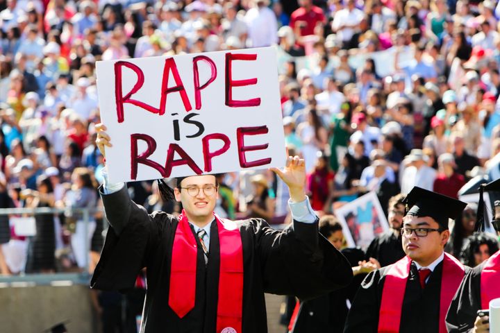 A Stanford student carries a timely sign during graduation ceremonies on June 12.