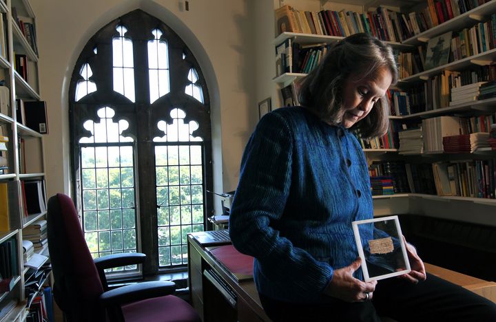 Karen L. King Hollis, Professor of Divinity at Harvard University, in her office with a papyrus fragment of the gospel of Jesus' wife.