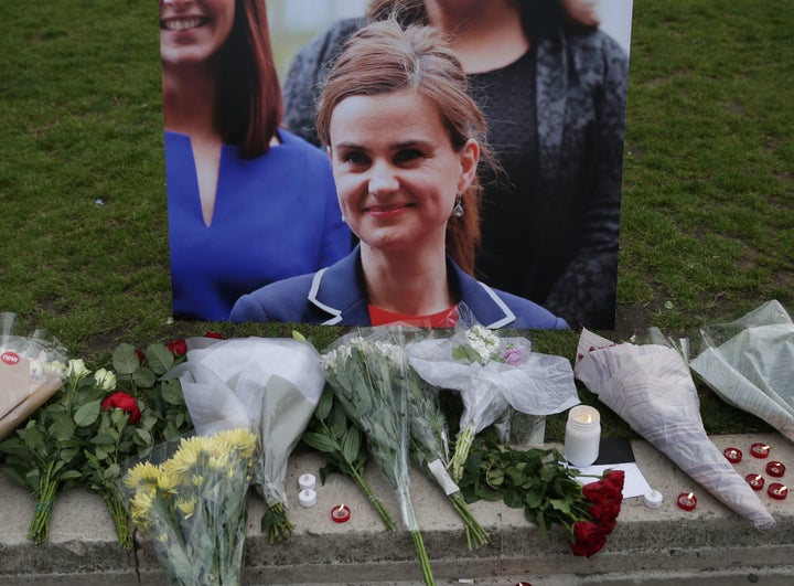 British member of Parliament Jo Cox was shot to death in northern England on Thursday. Above, floral tributes and candles are placed by a picture of Cox in Parliament square in London.