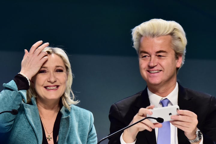 Geert Wilders (R) takes a selfie with Marine Le Pen during a press conference at the end of a gathering of European far-right
