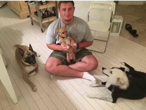 Alex Lewis with his two rescue pups Tootsie and Tino, and also holding his mom's rescue, Chester.