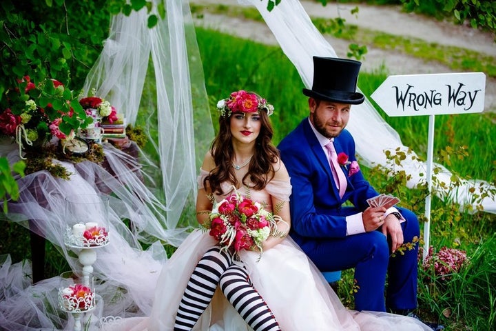 The Mad Hatter would definitely approve of the newlyweds' wacky attire. 