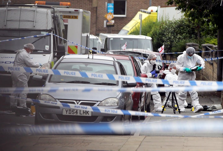 Forensics officers at the scene of the murder in Birstall, West Yorkshire 