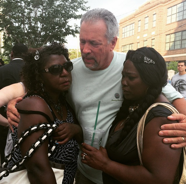 Mourners cry and pray outside Mother Emanuel on June 18, 2015, a day after the