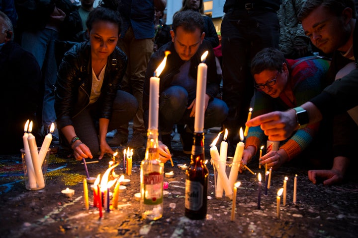 People light candles during a vigil for the victims of the Orlando nightclub shooting, on Old Compton Street, Soho on June 13