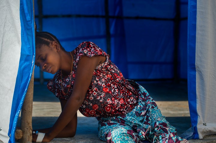 Mariatu Koroma, 18, four-months-pregnant, battles intense pain while waiting for an Ebola test in Port Loko, Sierra Leone, on Monday, November 24, 2014. Pregnant women are particularly vulnerable to the disease. 