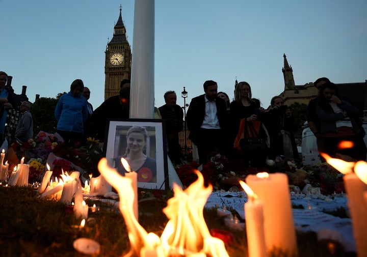 Mourners leave candles during a vigil at Parliament Square in London, in memory of murdered Labour Party member of parliament Jo Cox, who was shot dead in Birstall, northern England.