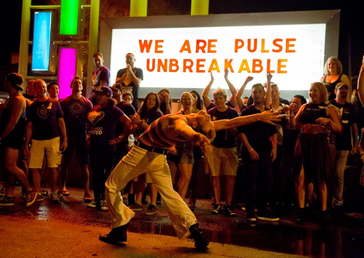 Steven Johnson dances among club goers as they gather outside Parliament House, an LGBT nightclub, late Saturday, June 18, 2016, in Orlando, Florida. The gathering is close to the one-week anniversary of the Pulse nightclub shooting .