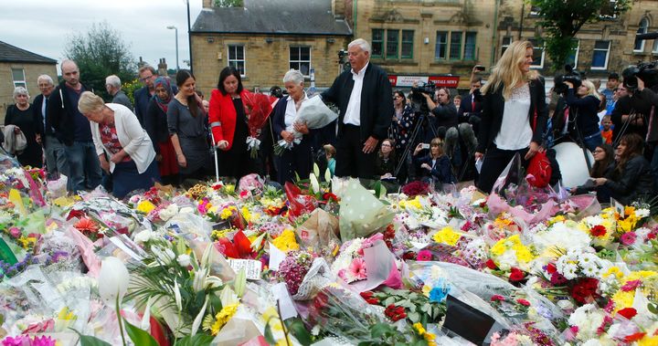 Gordon and Jean Leadbeater (centre), the parents of Labour MP Jo Cox, her sister sister Kim Leadbeater (right) lay flowers in Birstall