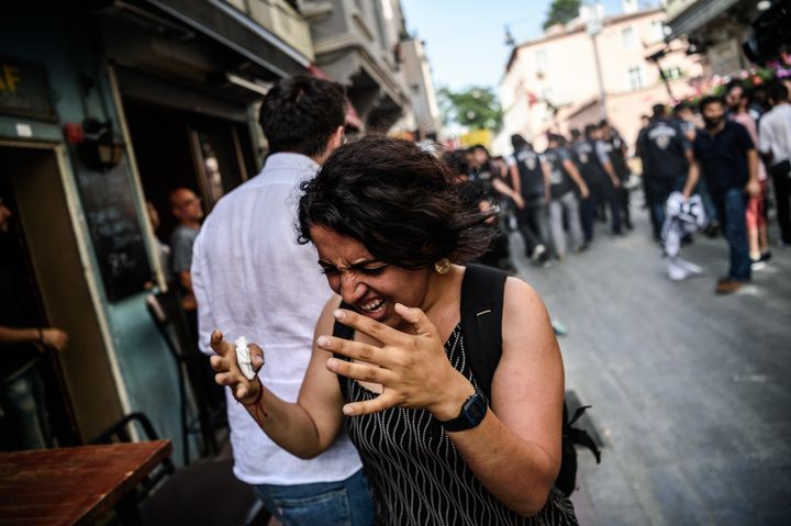 A woman reacts after tear gas was fired at the LGBT rally in Istanbul.