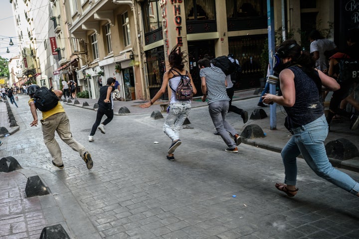 Demonstrators run as police forcibly disperse the rally.