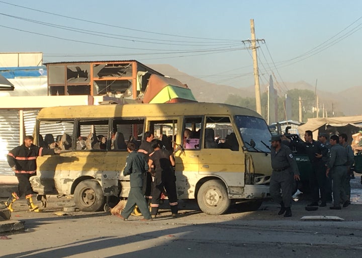 Police and fire fighters are seen at the site of a blast in Kabul on Monday.