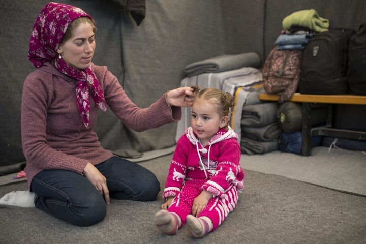 Makbola and her daughter Turqia play inside the tent where they stayed until a few weeks ago, when Idomeni camp was cleared o