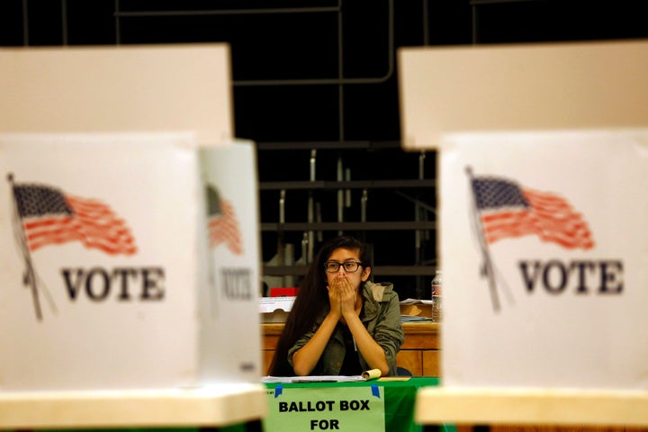 Election clerk Valerie Acosta waits for voters at the Kenter Canyon Elementary Charter School Auditorium.