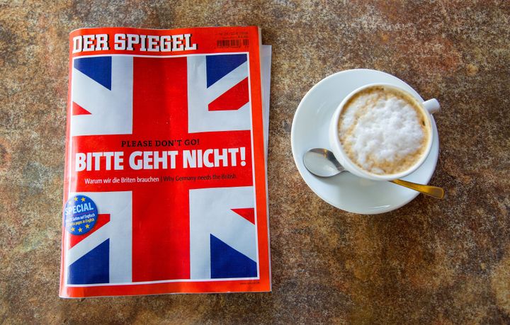 A copy of German magazine Der Spiegel featuring the headline 'Please don't go!' and a British Union flag illustration on the cover sits on a table next to a cup of coffee in this arranged photograph in Berlin, Germany