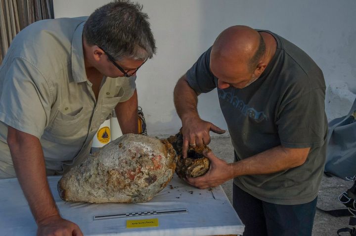 Project co-directors Brendan Foley and Theotokis Theodoulou inspect what may have been an ancient defensive weapon known as a dolphin.