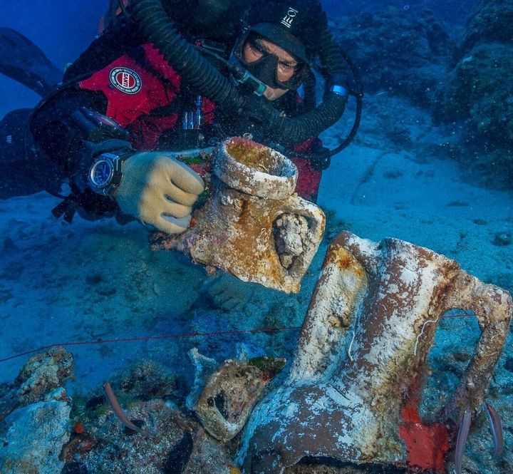 Foley, a marine archaeologist, compares amphora styles on the Antikythera shipwreck.