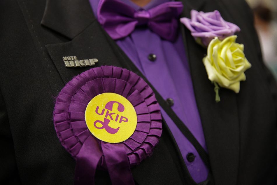 These might be classed as intimidating. Also only candidates and their polling agents are allowed to wear rosettes.