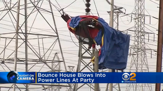 A bounce house sits in an electrical tower.