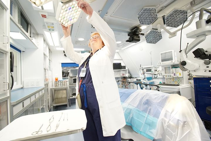 Dr. Rosalind Stevens adjusts the lights in the Operating Room of the Flying Eye Hospital.
