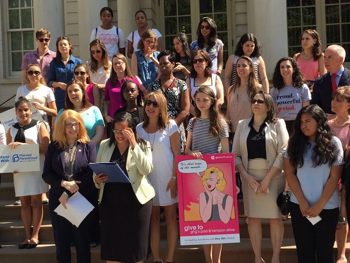 Council member Julissa Ferreras-Copeland (front, in black) stands with dozens of women on the steps of New York City Hall announcing the expected passage of a new bill bringing free tampons to schools, prisons and shelters, on June 21, 2016.
