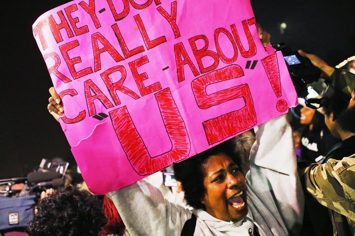 Demonstrators protest in front of the Ferguson police station on March 12, 2015.