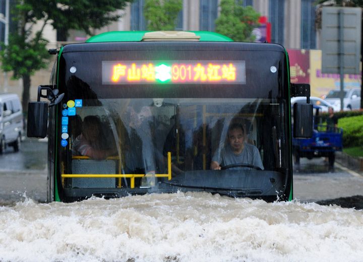 A bus goes through a flooded area in Jiujiang, Jiangxi Province, China, on June 19, 2016.