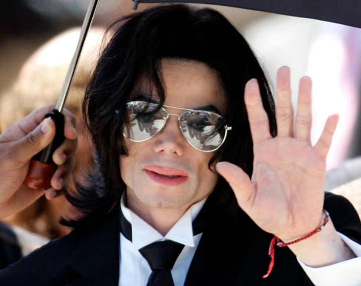 Michael Jackson waves to supporters as he leaves the Santa Barbara County Courthouse after he was found not guilty in Santa Maria, California June 13, 2005.