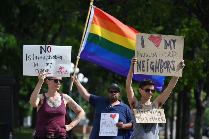 Lynne Sprague, left, Jeremy Bermudez, middle, and Andy Coco, right, who are part of the LGBTQ community, show their support for Muslims on June 12, 2016, in Denver.