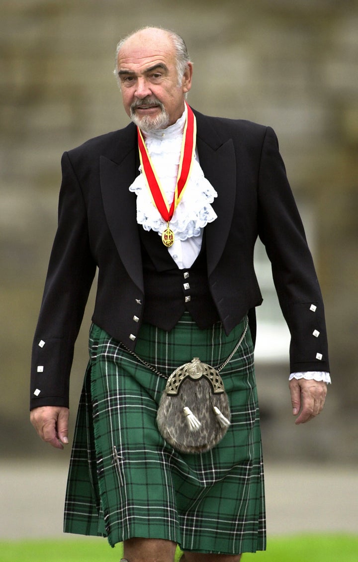 Connery wears full Highland dress and his medal after he was formally knighted by the queen in July 2000.