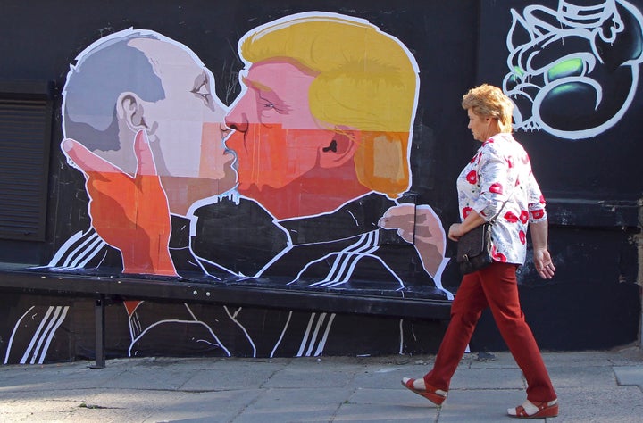 Donald Trump has shocked voters since the early days of the campaign with his praise for Russian President Vladimir Putin. Above, a woman walks past a mural of the two politicians on a restaurant wall in the Lithuanian capital of Vilnius.