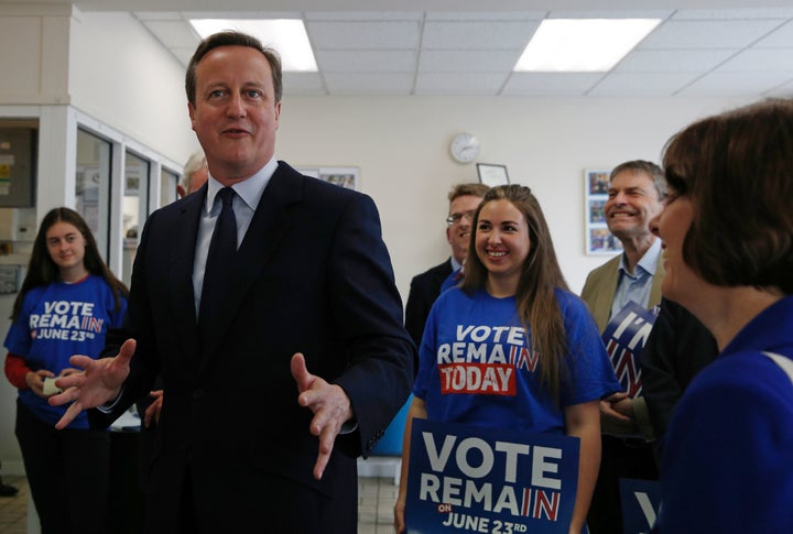 Britain's Prime Minister David Cameron speaks with campaign volunteers for the