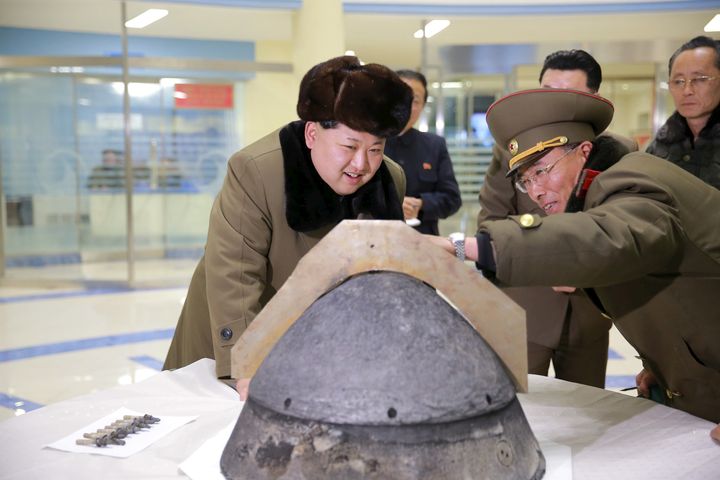 North Korean leader Kim Jong Un looks at a rocket warhead tip at an unidentified location in this undated photo released by North Korea's Korean Central News Agency (KCNA).