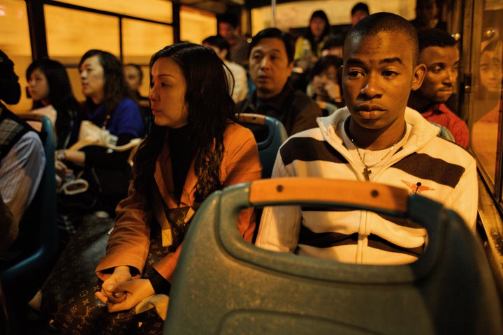 FILE PHOTO: An African trader sits on a bus in Guangzhou, China.