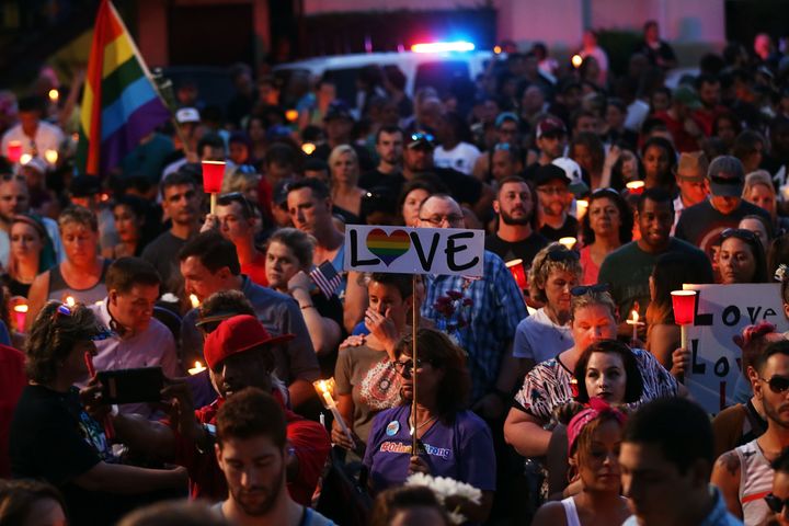 People attend a memorial service on June 19, 2016 in Orlando, Florida. Thousands of people are expected at the evening event which will feature entertainers, speakers and a candle vigil at sunset. 