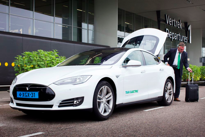 A Tesla Model S taxi picks up a passenger at Schiphol, Amsterdam's international airport.