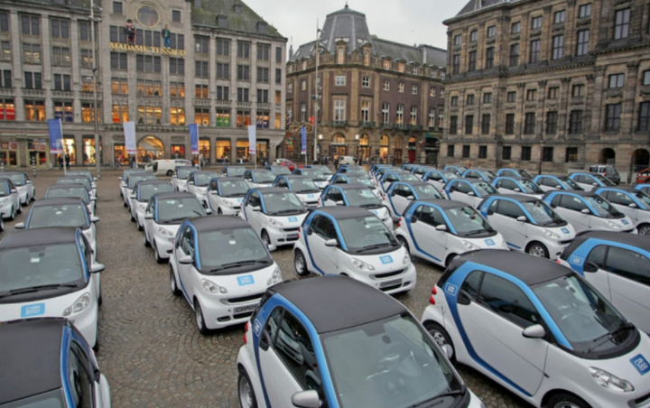 Electric cars fill Dam Square during car2Go's Amsterdam launch in 2011 .