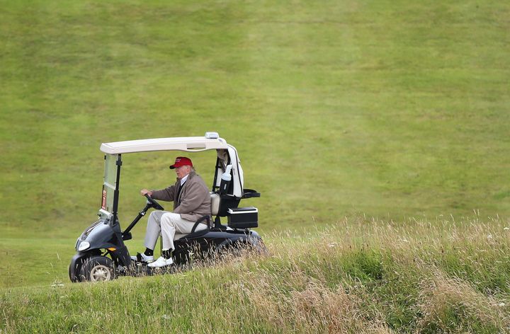 Trump pictured in a golf buggy on the Turnberry golf course last year