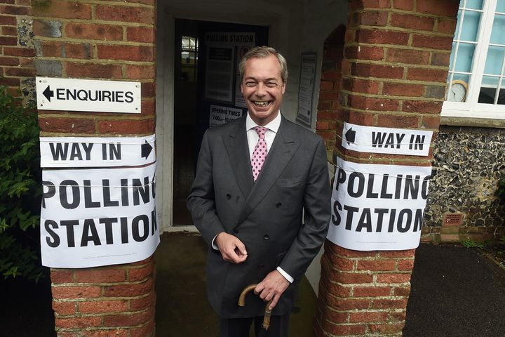 Nigel Farage poses for photographs ahead of voting.