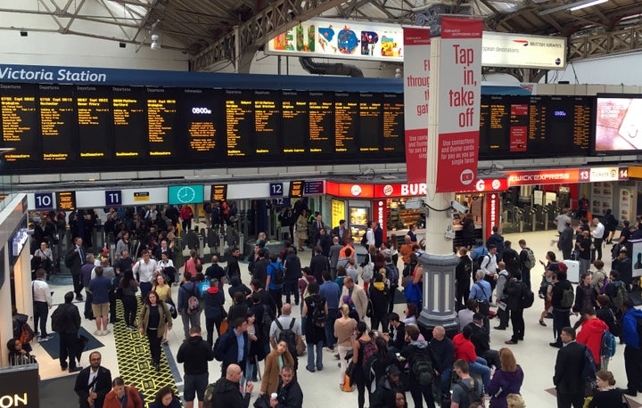 Commuters at Victoria Station as torrential downpours wreak havoc on the capital's transport system