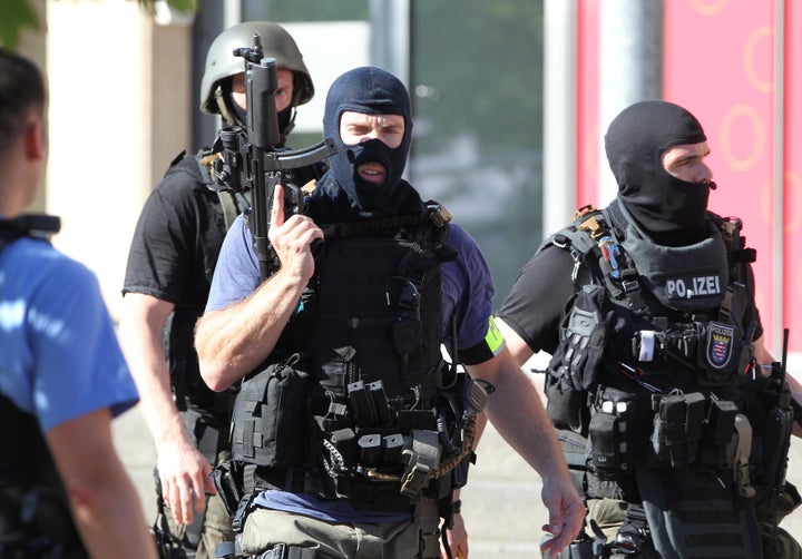 Policemen stand near a cinema where an armed man barricaded himself in Viernheim, southern Germany, on June 23, 2016.