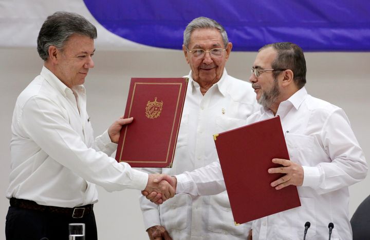 FARC commander Rodrigo Londono, better known by the nom de guerre Timochenko, shook hands with Colombian President Juan Manuel Santos at a ceremony to sign the deal in Havana.