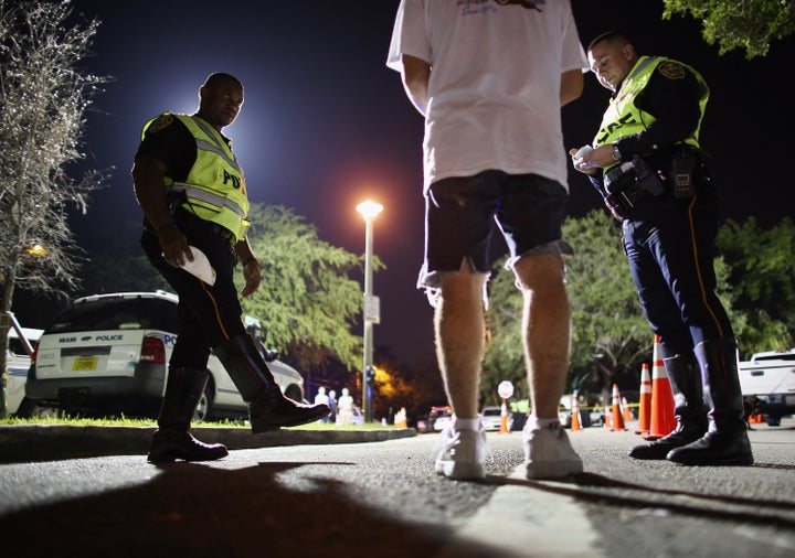 Officers conduct a field sobriety test on a driver during a DUI checkpoint on May 23, 2013 in Miami, Florida.