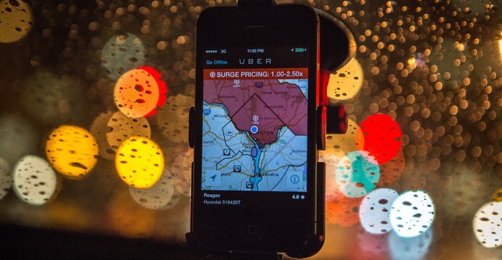 The Uber driver app on the windshield of UberX driver Regan Rucker indicates surge pricing during peak ridership on April 4,